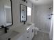 Bathroom showcasing double vanity, quartz countertop, and tiled walk-in shower at 16648 Sw 25Th Ct, Ocala, FL 34473