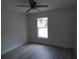 Cozy bedroom featuring wood-look flooring, ceiling fan, and natural light at 16648 Sw 25Th Ct, Ocala, FL 34473