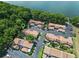 Aerial view capturing the townhouse community near the waterfront, with scenic trees and a serene atmosphere at 170 Lago Vista Blvd, Casselberry, FL 32707