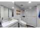 Full bathroom featuring a white vanity, toilet, and glass shower with natural light and wood-look flooring at 170 Lago Vista Blvd, Casselberry, FL 32707