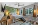 Cozy bedroom with custom green accent wall, contemporary furnishings and ample natural light at 170 Lago Vista Blvd, Casselberry, FL 32707
