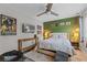 Well-lit bedroom with a ceiling fan, a bed, modern decor, and decorative green accent wall at 170 Lago Vista Blvd, Casselberry, FL 32707
