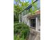 Charming two-story townhome exterior with dark framed windows and door and lush landscaping, creating a welcoming curb appeal at 170 Lago Vista Blvd, Casselberry, FL 32707