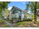 Two-story townhome showcasing a unique exterior paint scheme and mature landscaping, offering a distinctive curb appeal at 170 Lago Vista Blvd, Casselberry, FL 32707