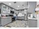 Modern kitchen with gray cabinets, stainless steel appliances and a stylish blue and gold rug at 170 Lago Vista Blvd, Casselberry, FL 32707