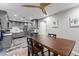 Kitchen with a dining table next to modern gray cabinets, and stainless steel appliances at 170 Lago Vista Blvd, Casselberry, FL 32707