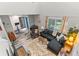 Open living room features a vaulted ceiling, modern furnishings, and large windows at 170 Lago Vista Blvd, Casselberry, FL 32707