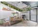 Covered patio with a wooden picnic table, grill, and a view of the lush backyard at 170 Lago Vista Blvd, Casselberry, FL 32707
