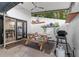Private outdoor patio with a wood picnic table, grill and white stucco walls at 170 Lago Vista Blvd, Casselberry, FL 32707