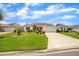 Inviting single-story home with patterned driveway, manicured lawn, and well-maintained landscaping at 17567 Se 81St Parnassus Ct, The Villages, FL 32162