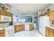 Spacious kitchen offers a view of the living spaces and a suite of essential appliances at 17567 Se 81St Parnassus Ct, The Villages, FL 32162