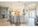 Bright kitchen features a breakfast bar with pendant lighting, wood cabinets, and modern appliances at 17567 Se 81St Parnassus Ct, The Villages, FL 32162