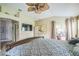 Partially viewed main bedroom showcases a ceiling fan and patio access, creating a relaxing retreat at 17567 Se 81St Parnassus Ct, The Villages, FL 32162