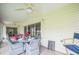 Inviting sunroom with large sliding glass doors, ceiling fan, and comfortable seating area at 17567 Se 81St Parnassus Ct, The Villages, FL 32162