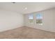 Well lit bedroom featuring neutral carpet, two windows, and a ceiling light at 1797 Red Canyon Dr, Kissimmee, FL 34744
