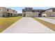 View of homes featuring attached garages and long driveways at 1797 Red Canyon Dr, Kissimmee, FL 34744