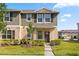 Charming two-story townhome featuring a well-maintained lawn and inviting entrance at 1797 Red Canyon Dr, Kissimmee, FL 34744