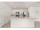 Well-lit kitchen with white cabinetry, stainless steel appliances, and large island at 1797 Red Canyon Dr, Kissimmee, FL 34744