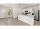 Modern kitchen featuring white cabinets, an island, and stainless steel appliances at 1797 Red Canyon Dr, Kissimmee, FL 34744