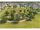 Aerial view of community playground with green spaces and sidewalks at 1797 Red Canyon Dr, Kissimmee, FL 34744