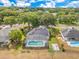 Aerial view of the house featuring a large screened-in pool, fenced yard, and solar panels on the roof at 1837 Sweetwater West Cir, Apopka, FL 32712