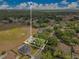Aerial view showcases the property with large backyard pool and green surrounding landscape at 1837 Sweetwater West Cir, Apopka, FL 32712