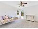 Bright bedroom with a floral bed, white dresser, carpet, and two windows bringing in natural light at 1837 Sweetwater West Cir, Apopka, FL 32712