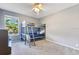 Cozy bedroom featuring a bunk bed, ceiling fan, and large window offering natural light and a serene view at 1837 Sweetwater West Cir, Apopka, FL 32712