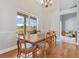 Bright dining room with wooden table, chairs, and a view of the outdoor pool through the window at 1837 Sweetwater West Cir, Apopka, FL 32712