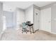 Hallway featuring neutral tones, carpet, doors, and a keyboard with a stool, providing a versatile space at 1837 Sweetwater West Cir, Apopka, FL 32712