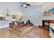 Spacious living room featuring a fireplace, high ceilings, and seamless access to an open-concept kitchen and dining area at 1837 Sweetwater West Cir, Apopka, FL 32712