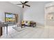 Open living room with tile flooring and access to screened patio at 1837 Sweetwater West Cir, Apopka, FL 32712