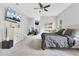 A well-lit main bedroom with a large bed, TV, and open access to an exercise area at 1837 Sweetwater West Cir, Apopka, FL 32712