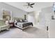 Spacious main bedroom with large windows, a neutral color palette, and open access to the bathroom at 1837 Sweetwater West Cir, Apopka, FL 32712