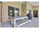Covered patio featuring a dining table, bench, grill, and seamless indoor-outdoor flow through sliding glass doors at 1837 Sweetwater West Cir, Apopka, FL 32712