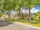 Charming two-story home with a well-manicured lawn and mature trees, featuring a two car garage at 1837 Sweetwater West Cir, Apopka, FL 32712