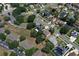 A high angle view of a home nestled within a community full of mature trees and winding roads at 211 Hunt St, Clermont, FL 34711