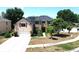 Aerial view of a two-story home featuring solar panels, a manicured lawn, and mature trees at 211 Hunt St, Clermont, FL 34711