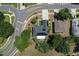 Aerial view of a home featuring solar panels and a covered patio surrounded by lush greenery and mature trees at 211 Hunt St, Clermont, FL 34711