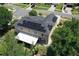 Birds eye view of a two-story home with solar panels and covered patio, highlighting roof and backyard at 211 Hunt St, Clermont, FL 34711