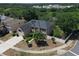 Aerial view of a two-story home featuring solar panels, a manicured lawn, and mature trees with a cul-de-sac at 211 Hunt St, Clermont, FL 34711