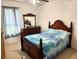 Comfortable bedroom features a bed, ceiling fan, window, and dresser at 211 Hunt St, Clermont, FL 34711