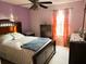Comfortable bedroom features a decorative ceiling fan and lots of natural light from the window at 211 Hunt St, Clermont, FL 34711