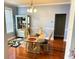 A dining room with hardwood floors featuring ornate glass table and decor at 211 Hunt St, Clermont, FL 34711