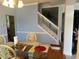 Light-filled dining room with hardwood floors and staircase to the upper level at 211 Hunt St, Clermont, FL 34711