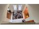 Foyer area viewed from stairs, showcasing tiled floor, rug, and French doors at 211 Hunt St, Clermont, FL 34711