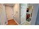Hallway with hardwood floors that leads to kitchen, offering a glimpse of the home's layout at 211 Hunt St, Clermont, FL 34711