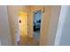 Bright hallway leading to a bedroom, showcasing tiled floors and neutral wall colors at 211 Hunt St, Clermont, FL 34711