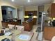 Well-equipped kitchen showcasing wood cabinets, an island, and modern appliances at 211 Hunt St, Clermont, FL 34711