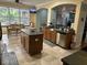 Well-lit kitchen with island, stainless appliances, and large windows for natural light at 211 Hunt St, Clermont, FL 34711